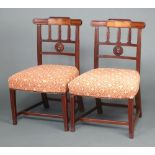 A pair of 19th Century mahogany inlaid stick and rail back dining chairs with overstuffed seats