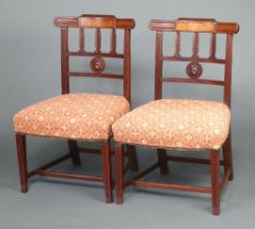 A pair of 19th Century mahogany inlaid stick and rail back dining chairs with overstuffed seats