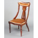 An Edwardian inlaid mahogany slat back bedroom chair, the seat of serpentine outline, raised on