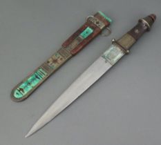 An Eastern double bladed dagger with 26cm blade, horn grip and leather scabbard with metal mounts