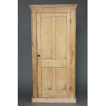 A Victorian pine wardrobe with moulded cornice, fitted a shelf and hanging space above a recess,