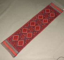 A red and black ground Meshwani runner with 14 diamonds to the centre 234cm x 57cm