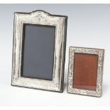 A modern embossed 925 standard easel photograph frame 11cm x 8cm, together with a silver