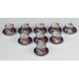 Nine Chinese miniature porcelain coffee cans and saucers with figural decoration, the bases with 6