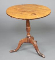 An 18th Century circular oak snap top tea table raised on a pillar and tripod base 68cm h x 68cm