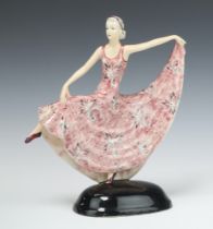 An Art Deco pink glazed pottery figure of a standing dancing lady 31cm h x 28cm Foot cracked