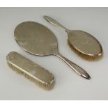 A silver handled clothes brush Birmingham 1917 together with a Sterling silver backed hand mirror