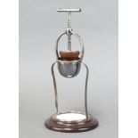 A 19th Century silver plated and mahogany lemon squeezer with ceramic tile to the base 33cm x 15cm