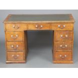 A Victorian oak desk with green leather writing surface above 1 long and 8 short drawers 82cm h x