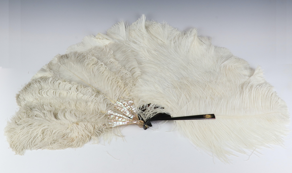 A tortoiseshell and ostrich feather van together with a mother of pearl and ostrich feather fan