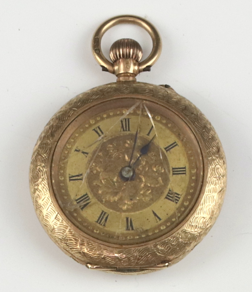 A keyless fob watch contained in a gilt metal case The back is a/f and the class is cracked