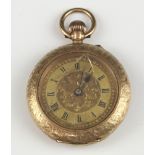 A keyless fob watch contained in a gilt metal case The back is a/f and the class is cracked