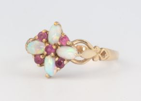 A 9ct yellow gold dress ring set rubies and opals size R 1/2, 2.7 grams