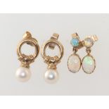 A pair of yellow metal opal set earrings together with a yellow metal pair of pearl drop earrings,