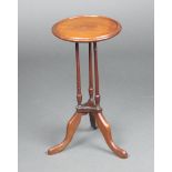 An Edwardian circular mahogany dish top wine table, raised on 3 turned columns with outswept