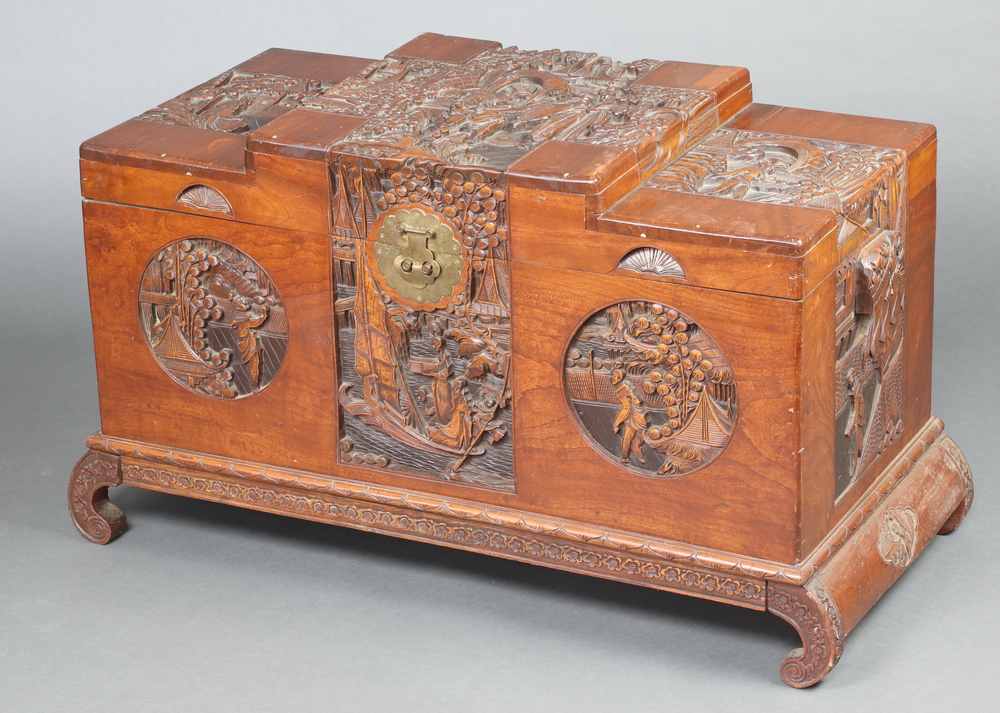 A 1930's Chinese carved camphor coffer with hinged lid, on cabriole supports, having a