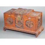 A 1930's Chinese carved camphor coffer with hinged lid, on cabriole supports, having a