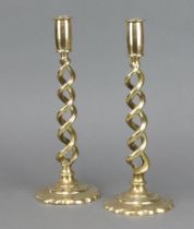 A pair of Victorian brass spiral turned candlesticks on petal bases 29cm