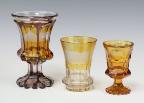 A 19th Century Bohemian amber glass hexagonal panelled goblet with etched building decoration