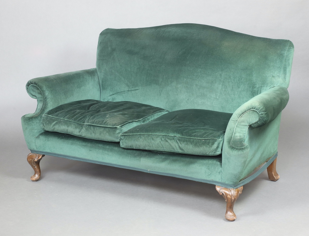 A near pair of Queen Anne style two seat sofas upholstered in green material, raised on cabriole