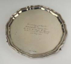 A silver salver with bracketed border raised on scroll supports Sheffield 1934, 26cm, with
