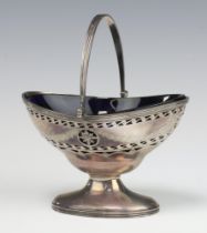A Victorian oval pierced silver boat shaped sugar bowl with swing handle, Birmingham 1862 by S