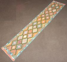 A blue, black, green and tan ground Maimana Kilim runner with all over geometric design 390cm x 80cm