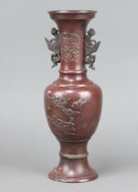 A 19th Century Japanese bronze twin handled urn with stylised handles and dragon decoration 32cm x