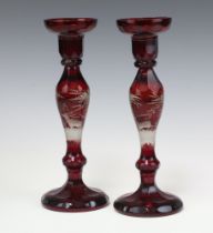 A pair of Bohemian red overlay glass candlesticks decorated stags 28cm Contact marks to the base