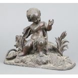 A 19th Century spelter figure of a seated cherub on an oval base 17cm x 23cm x 8cm