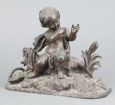 A 19th Century spelter figure of a seated cherub on an oval base 17cm x 23cm x 8cm