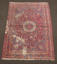 A blue and red ground Persian rug with central medallion 208cm x 136cm With heavy moth