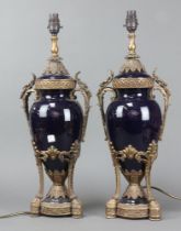 A pair of blue porcelain and gilt metal mounted twin handled table lamps in the form of lidded