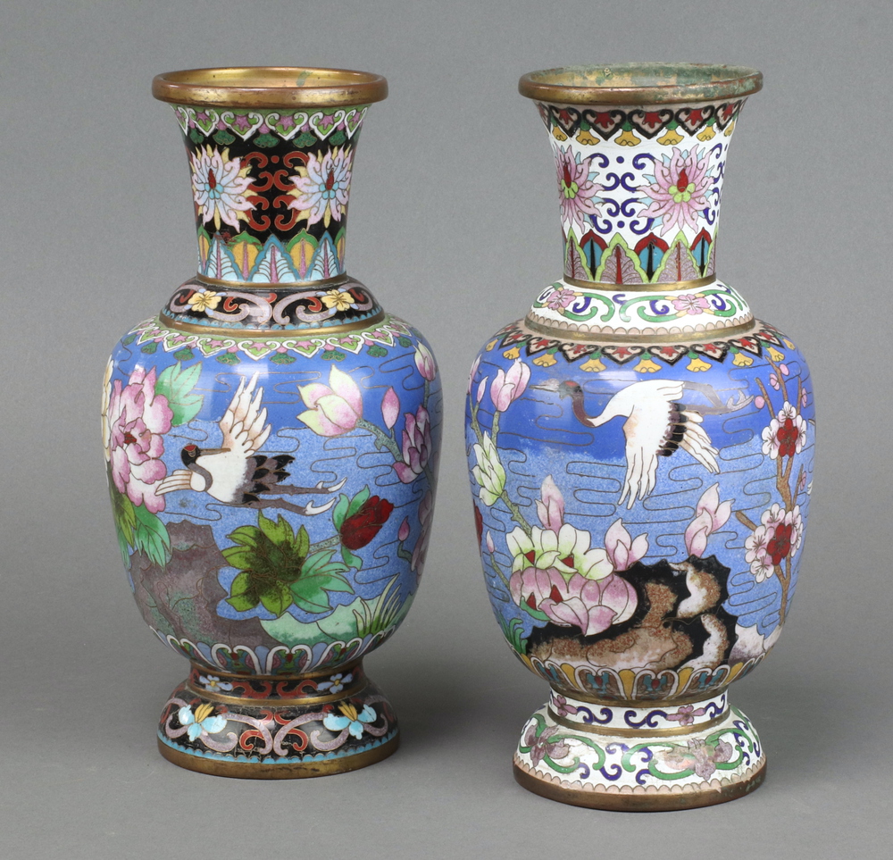 A pair of blue ground cloisonne enamelled vases decorated storks in landscape 27cm One has a chip