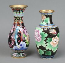 A Japanese black ground cloisonne enamel waisted club shaped vase decorated a bird on a circular