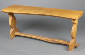 A 20th Century rectangular elm side table on standard end supports with H framed stretcher 70cm h