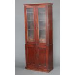 A Victorian mahogany cabinet on cabinet, the upper section fitted shelves above an arrangement of