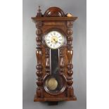 A Vienna style regulator wall clock with 18cm paper dial, Roman numerals contained in a walnut