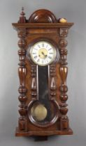 A Vienna style regulator wall clock with 18cm paper dial, Roman numerals contained in a walnut