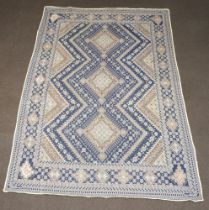 A blue and white ground Persian panel with 3 diamonds to the centre 296cm x 194cm, signed to each