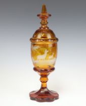 A 19th Century Bohemian amber glass jar and cover decorated stag and deer 37cm h Bruise/crack to the