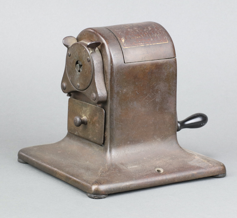 Sloan's, a desk mounted pencil sharpener 18cm h x 17cm w x 16cm d Hinge to the top is broken