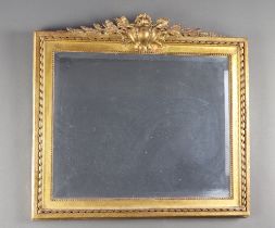 A 19th Century style rectangular bevelled plate wall mirror contained in a decorative gilt painted