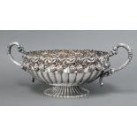 An oval embossed silver plated twin handled bowl raised on a spreading foot decorated strawberries
