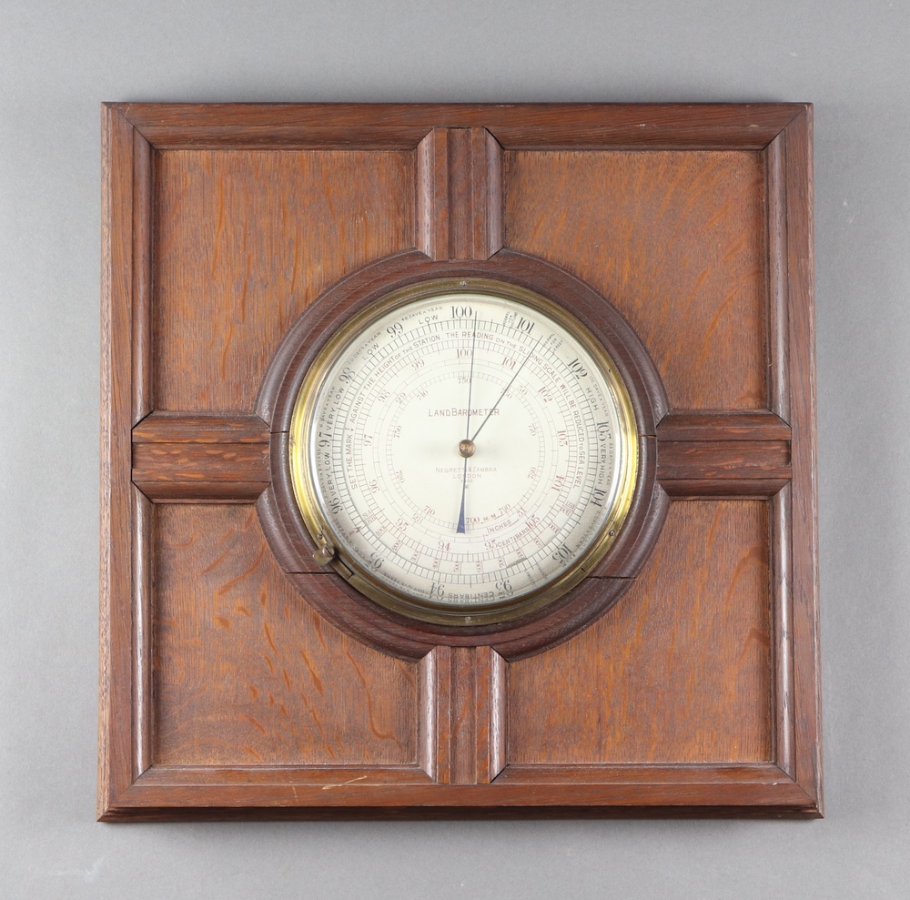 Negretti and Zambra, a land barometer, the 20cm silvered dial marked 3402, contained in an oak