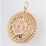 A pierced yellow metal pendant set a ruby 19.4 grams