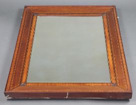 An Edwardian rectangular bevelled plate mirror contained in an inlaid mahogany frame with fleur de