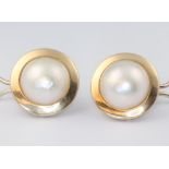 A pair of yellow metal marked 750 and large Mabe pearl earrings, the pearls set in a flat circular