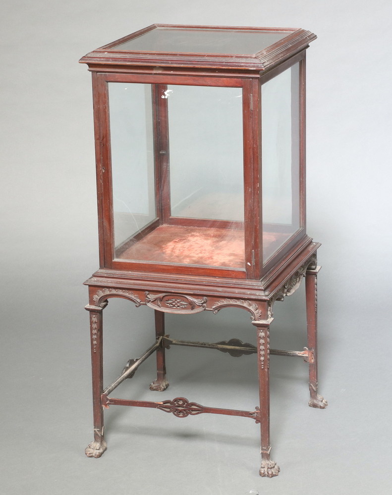 An Edwardian Chippendale style mahogany and glazed pedestal display cabinet enclosed by a panelled