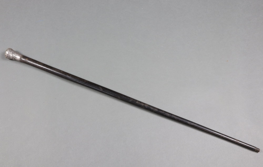 An Indian ebony walking cane with embossed white metal knop